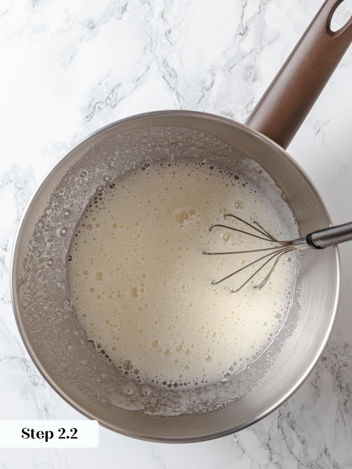 Egg whites and sugar whisked together while heating to dissolve sugar completely.