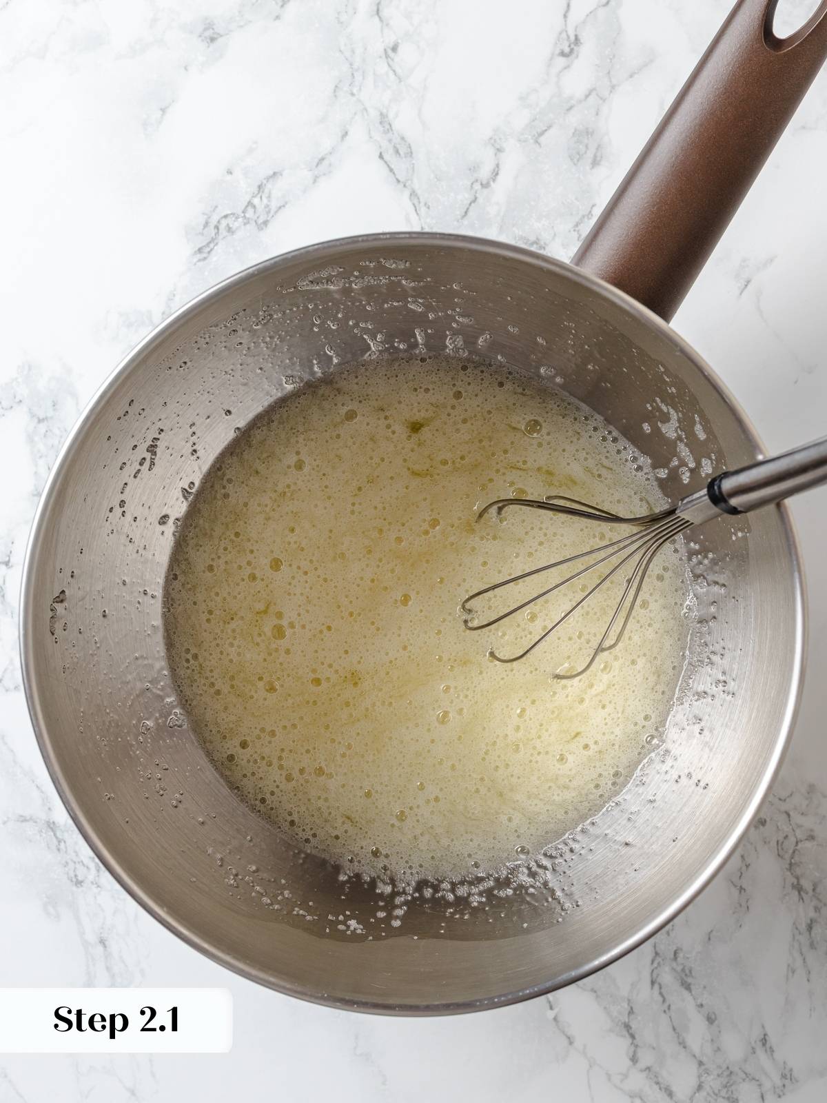 Egg whites and sugar gently heated over simmering water while whisking constantly.