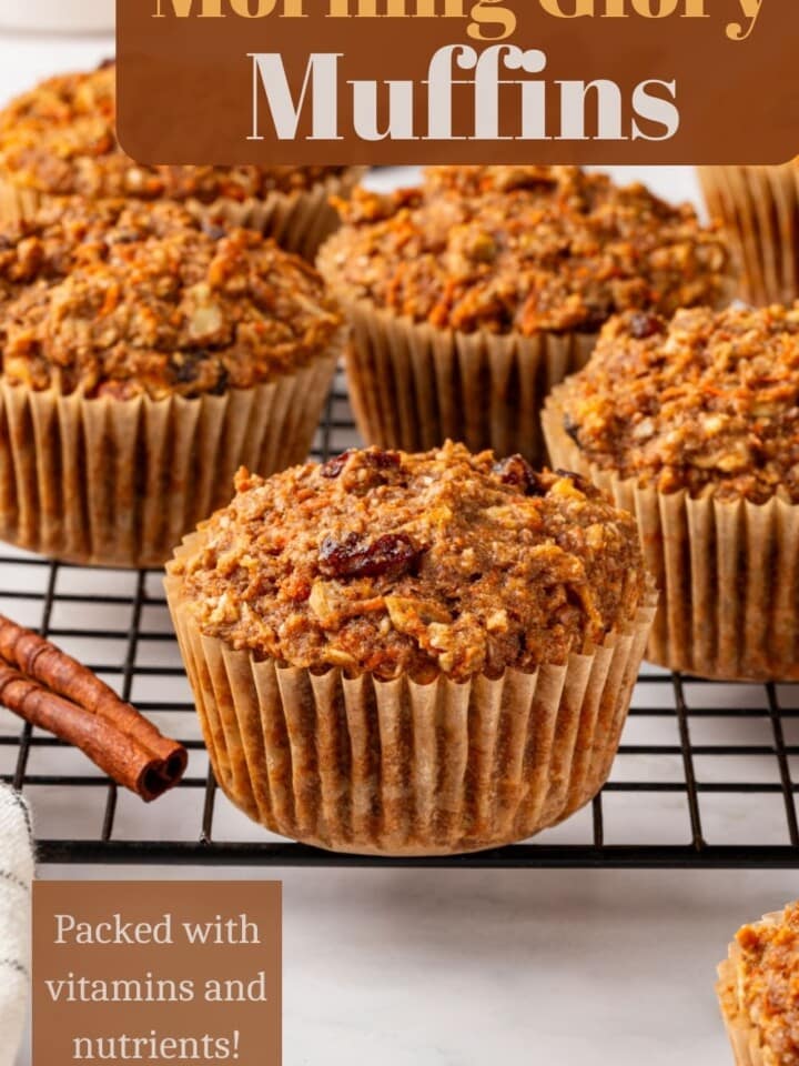 Healthy carrot apple muffins cooling on a rack after baking in paper liners.