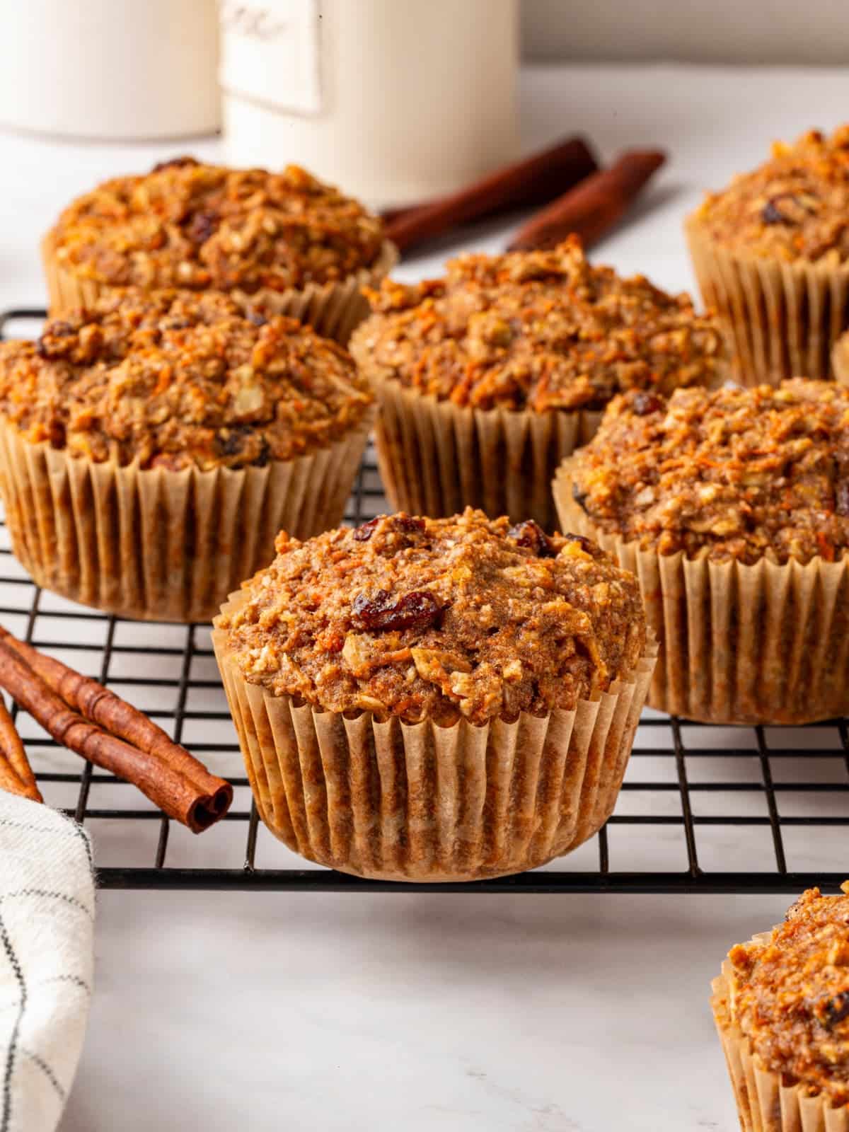 Carrot raisin muffins baked until tender with visible fruit pieces inside crumb.
