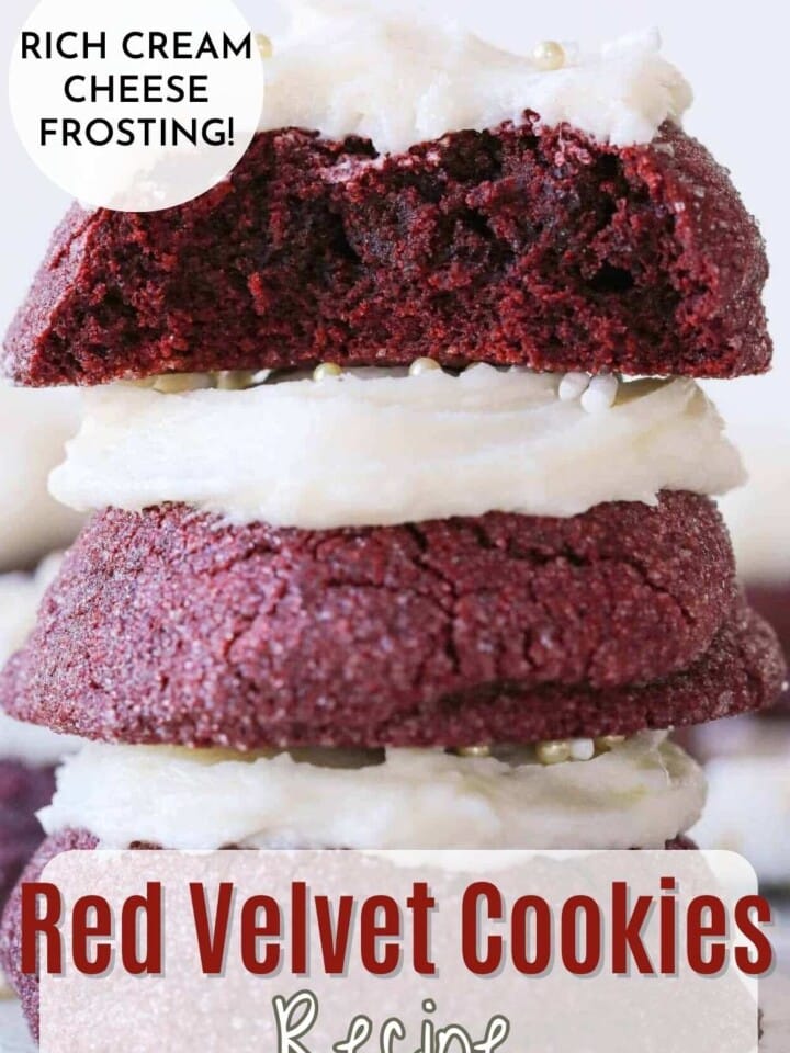Red velvet cookies with vanilla buttercream frosting stacked and showing soft chewy centers.