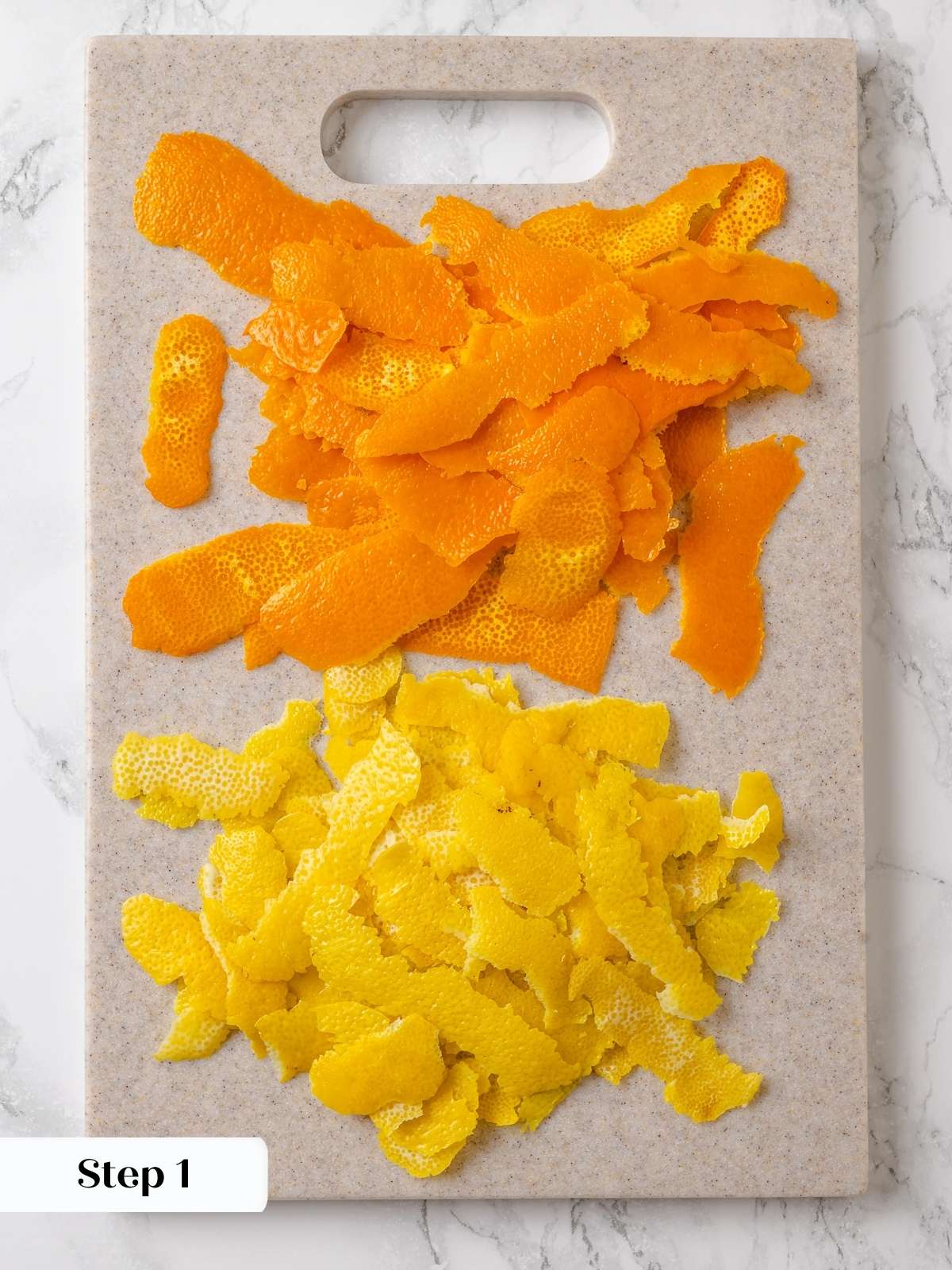Freshly peeled orange and lemon rinds prepared for slicing and blanching.