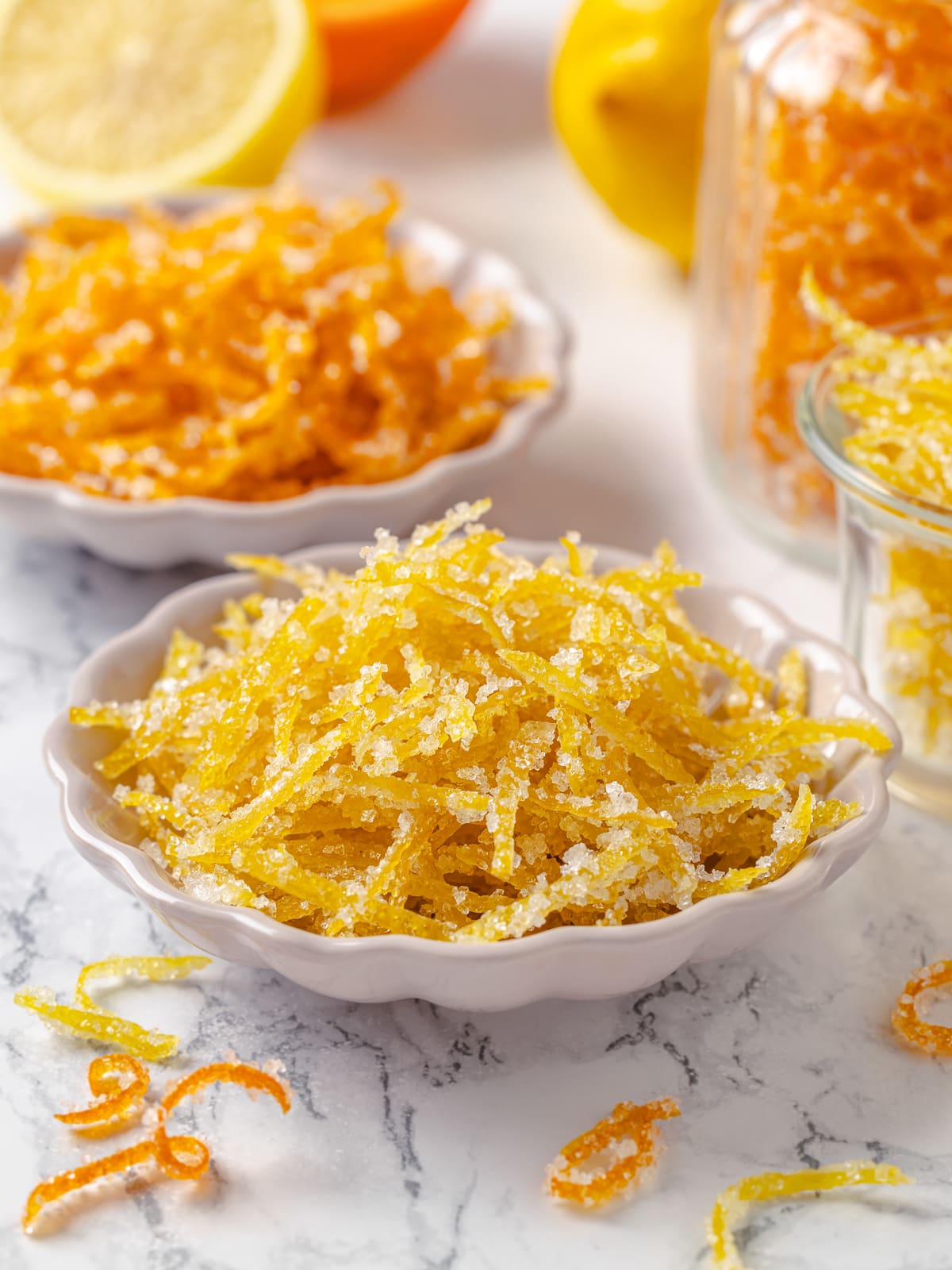 Candied citrus peel served in white bowls, highlighting color and glossy texture.