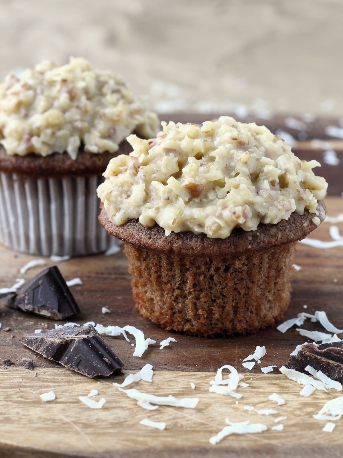 Freshly frosted German chocolate cupcakes with thick coconut pecan topping.
