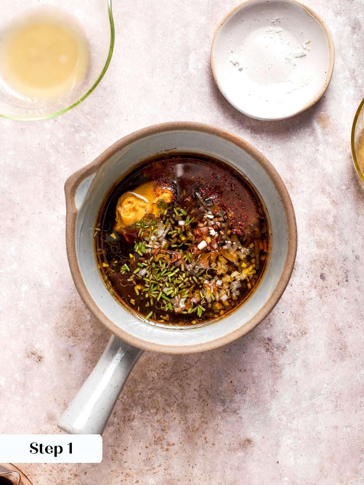 Measured balsamic, lemon juice, Dijon, and shallot in measuring cup.