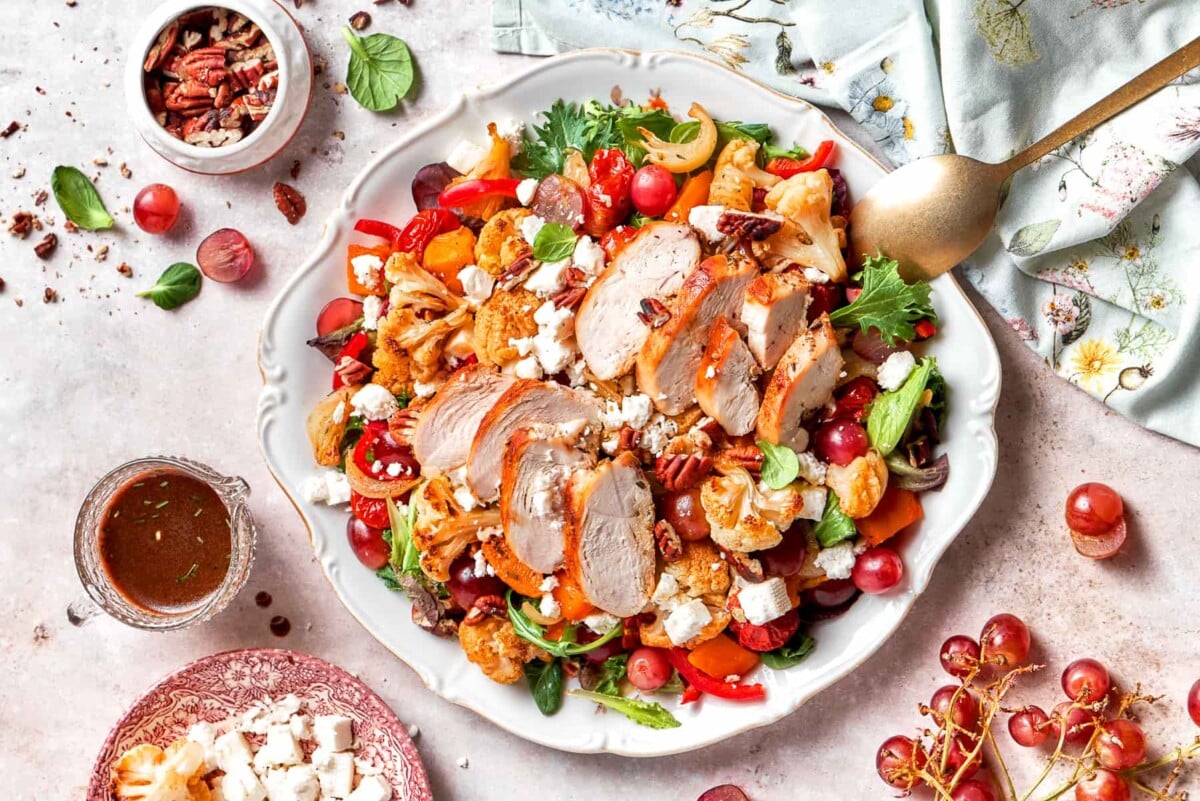 Roughly chopped pecans topping warm roasted vegetables and greens.