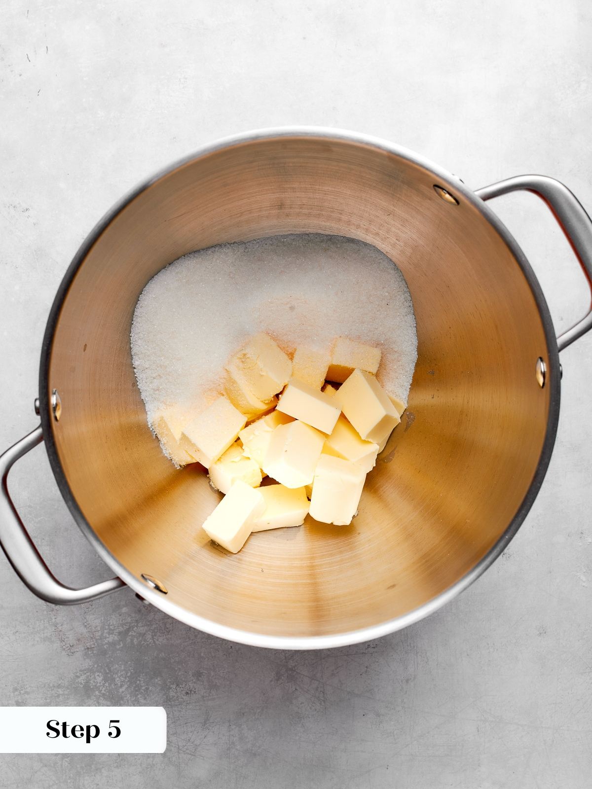 Creaming butter and sugar to create airy structure for chocolate cake batter.