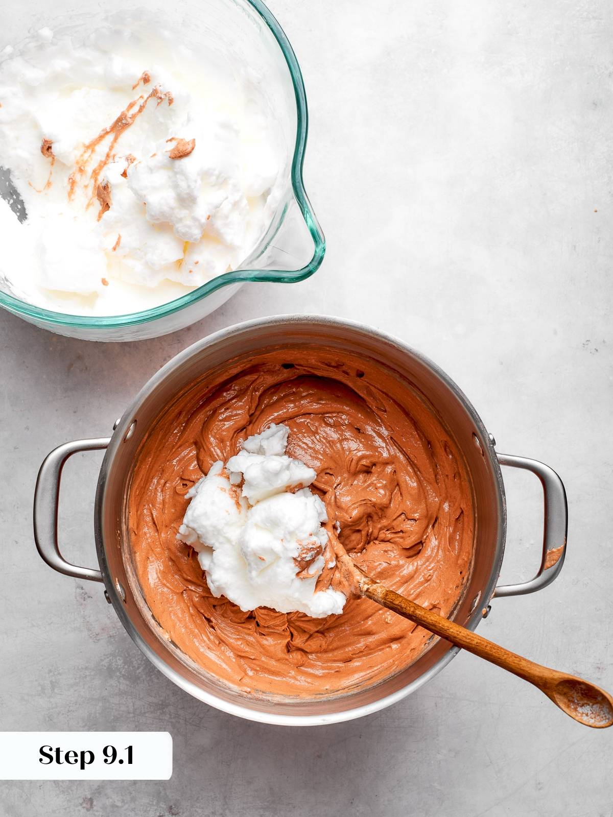 Spoon folding stiff egg whites into cake batter to keep mixture airy.