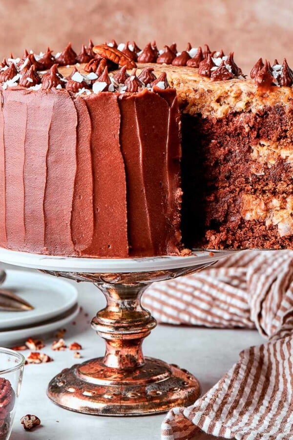 Cake server lifting slice of German chocolate cake from layered dessert.