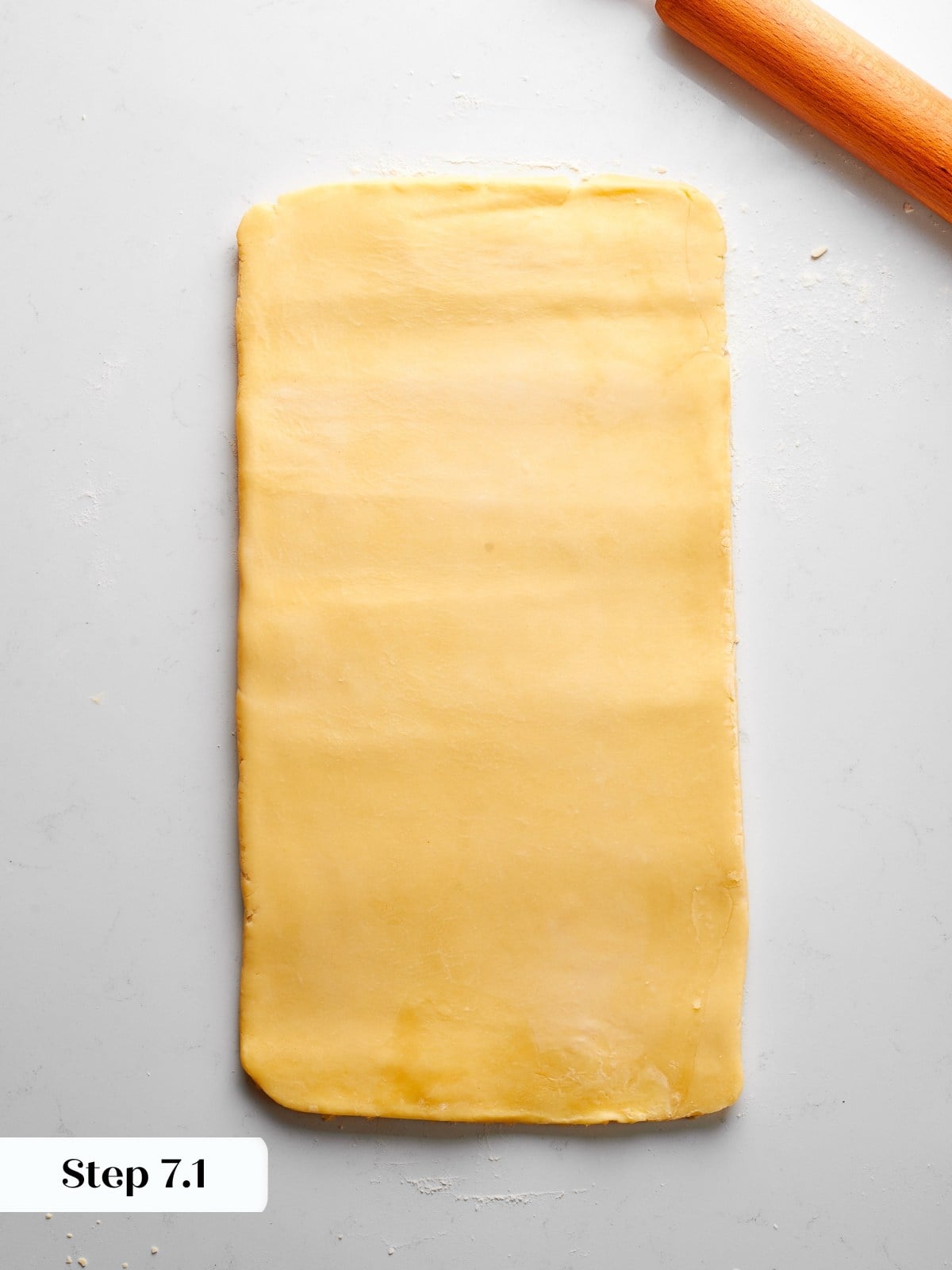 Laminated dough rolled out again into a long rectangle before next fold.