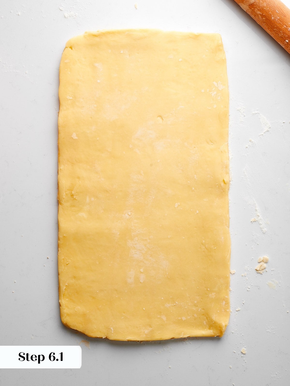 Dough rolled into a long rectangle with even thickness before performing first fold.
