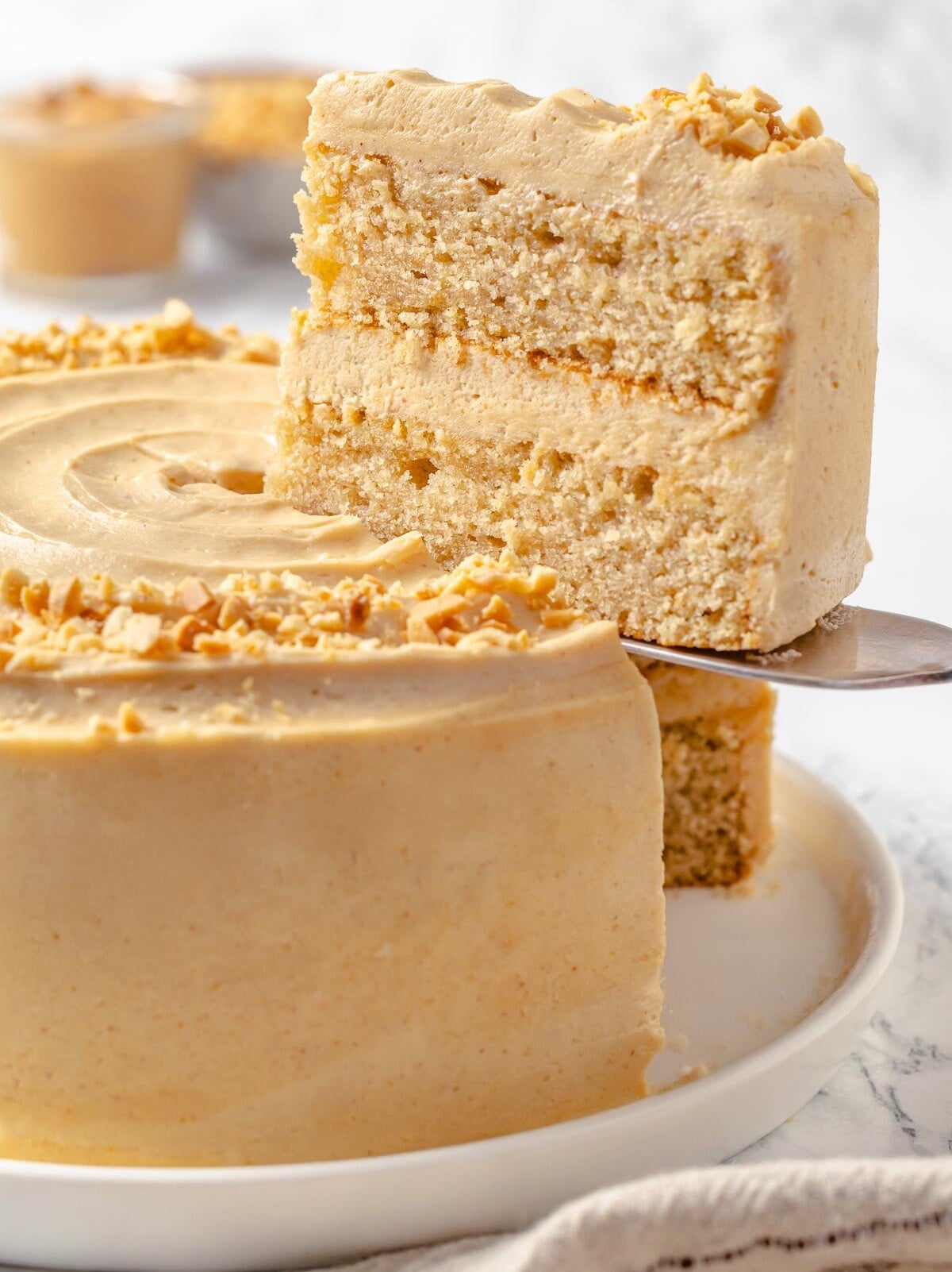 Thick layer of peanut butter buttercream spread between chocolate cake layers.