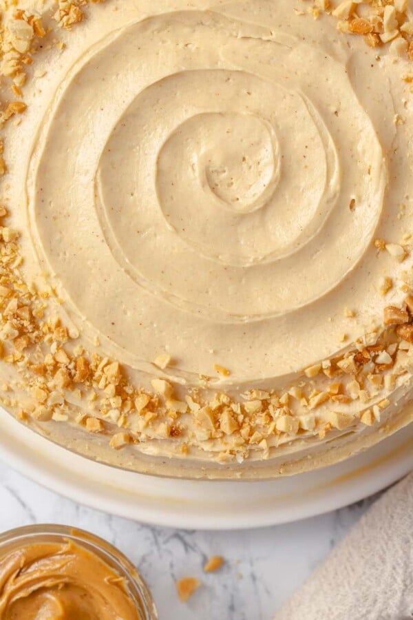 Peanut butter buttercream cake topped with chopped roasted peanuts for crunch.