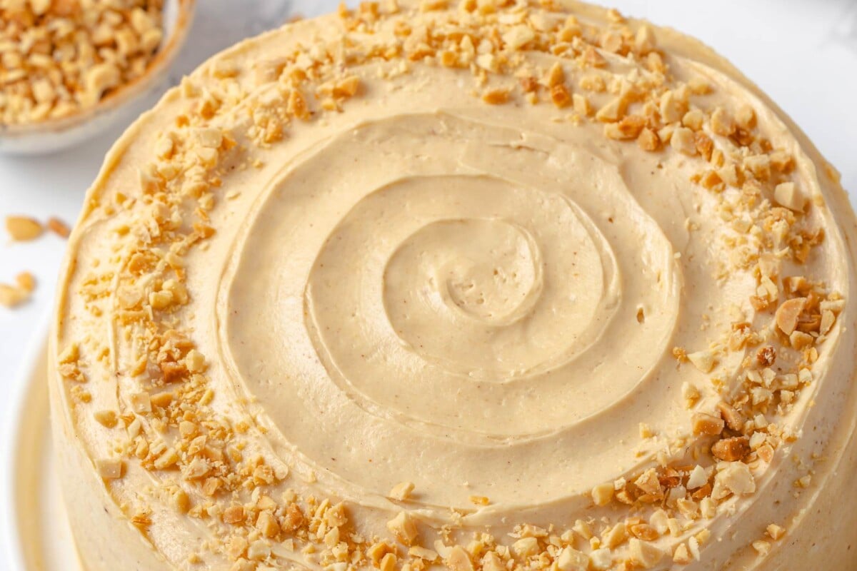 Layer cake decorated with fluffy peanut butter buttercream smooth frosting.
