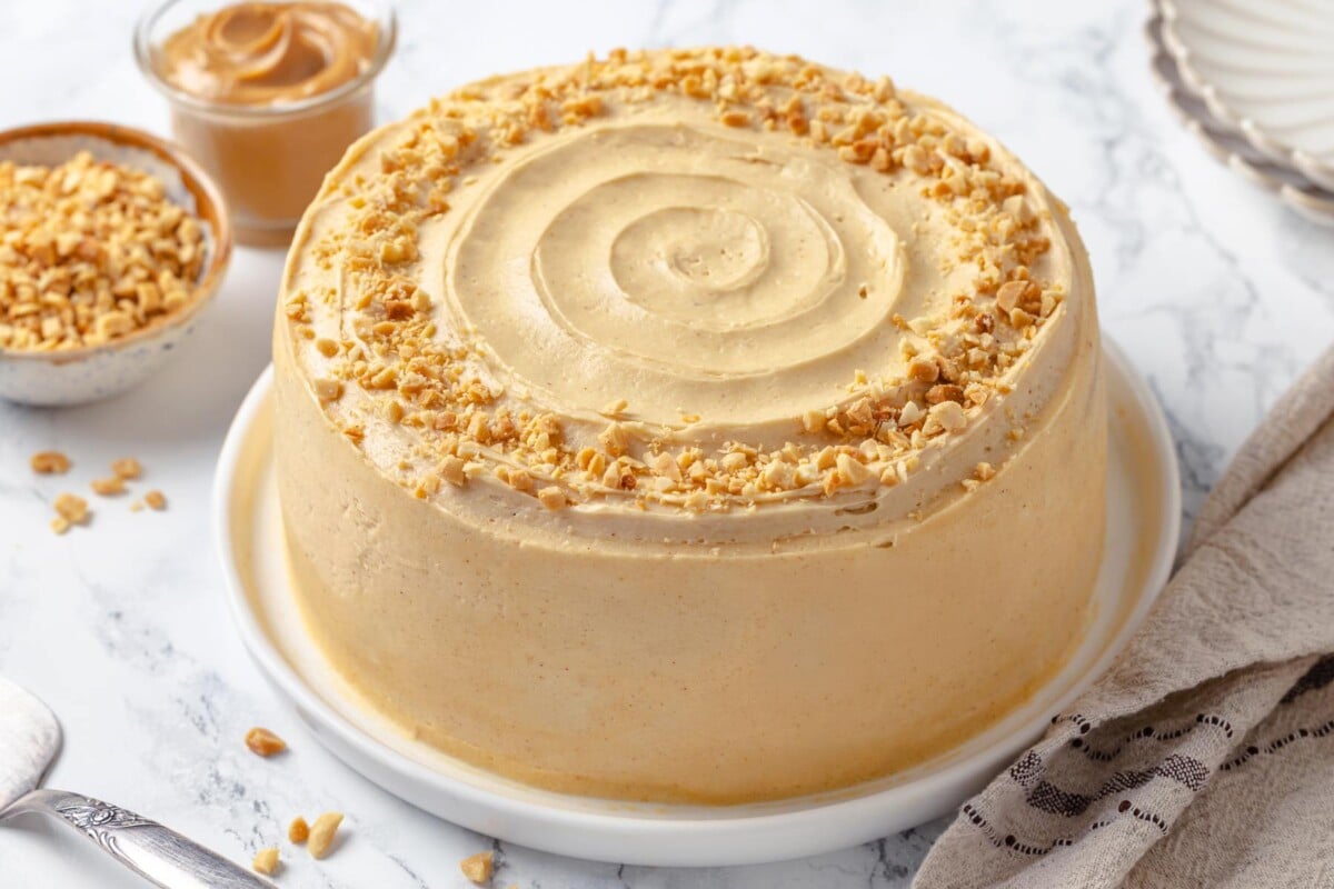 Light, fluffy peanut butter frosting spread on peanut butter layer cake.