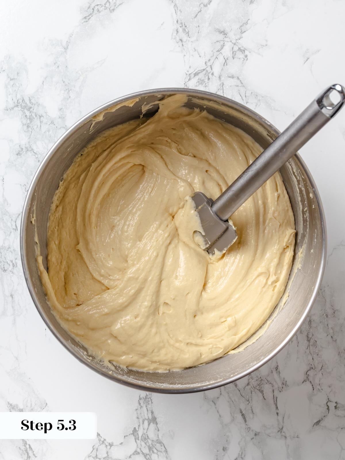 Smooth peanut butter cake batter ready for dividing into pans.