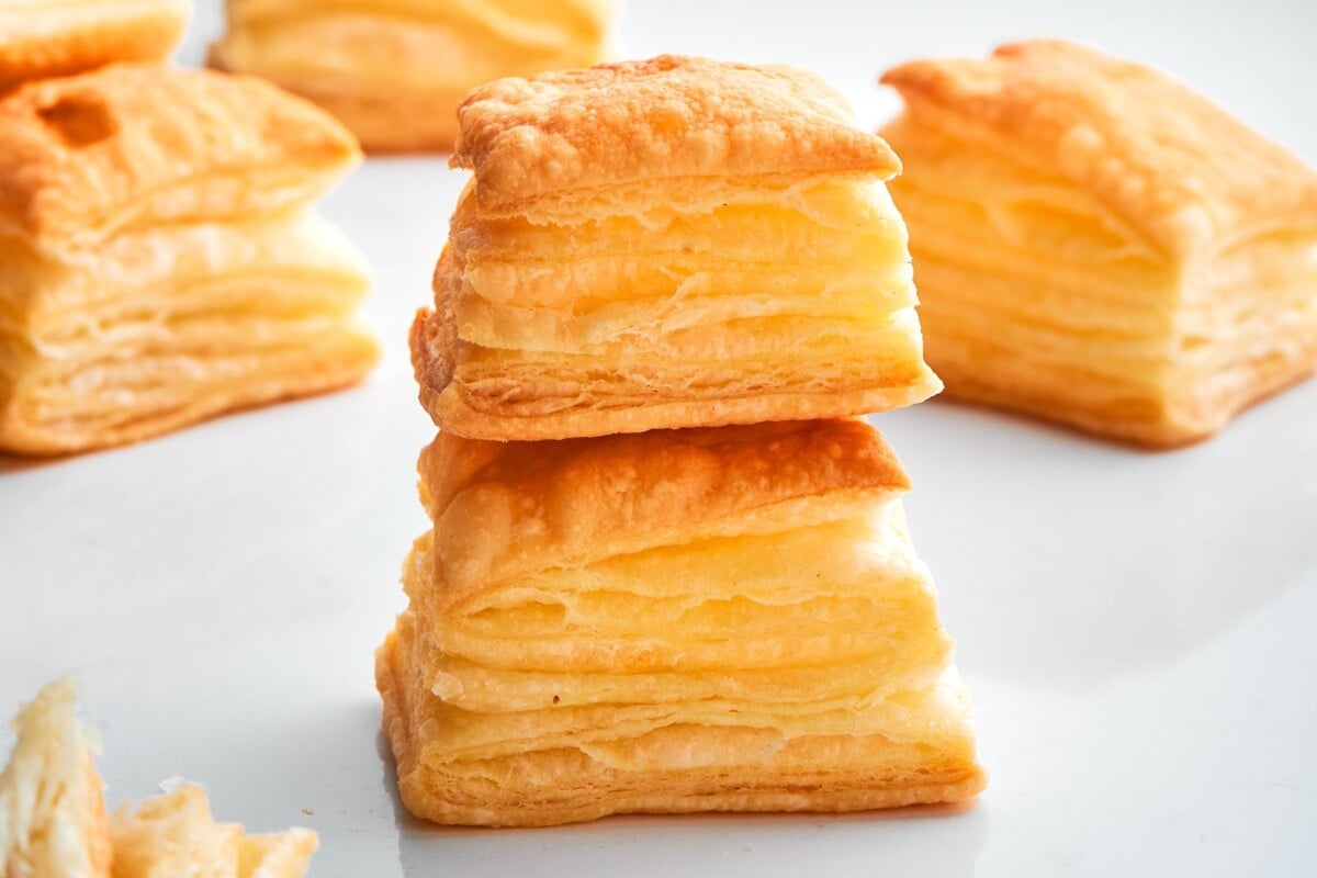 Group of baked puff pastry bites arranged together showing golden color and flaky texture.