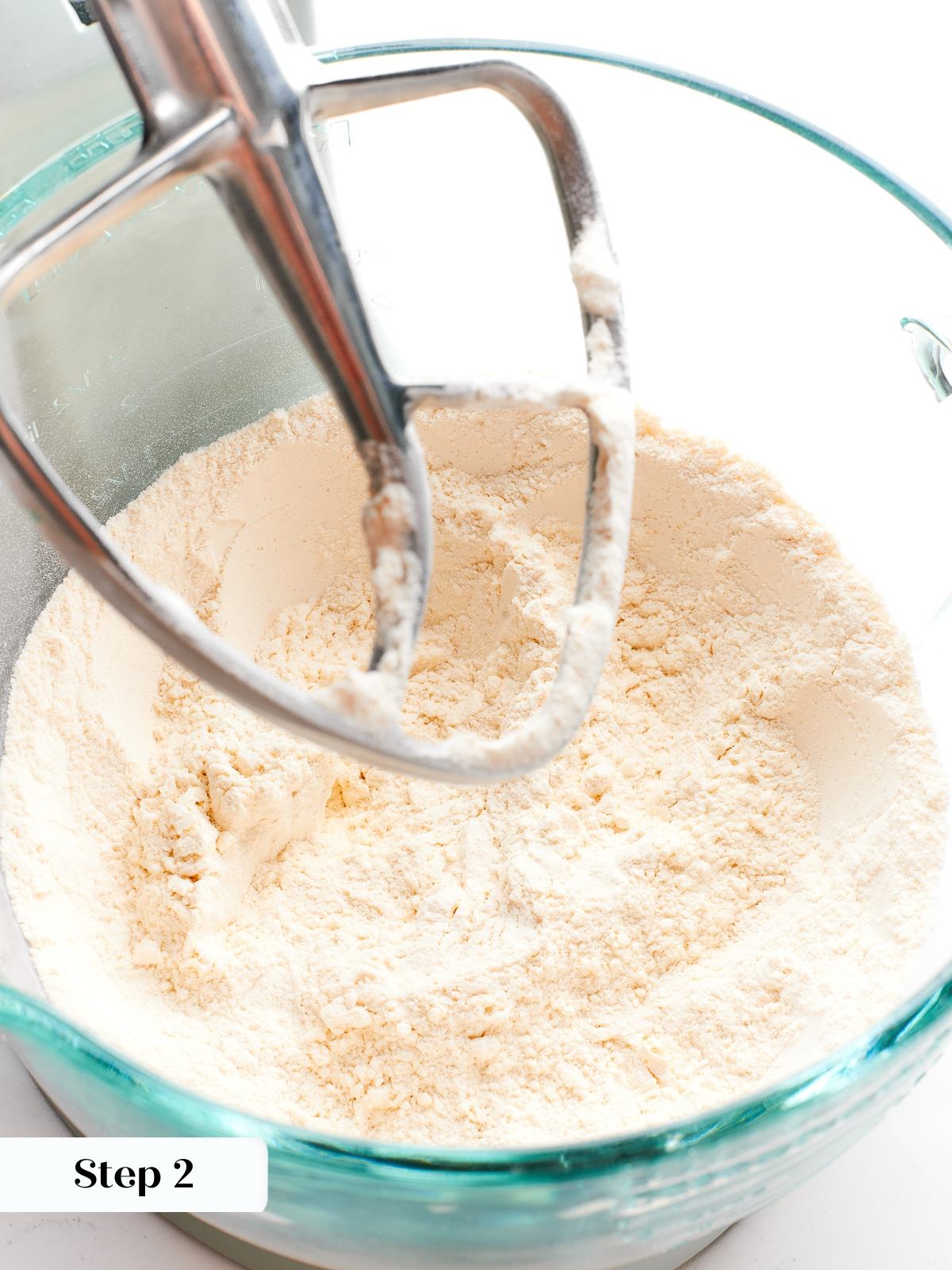 Flour, sugar, and salt combined in bowl to form base of puff pastry dough.