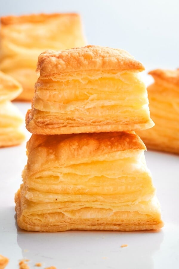 Two golden puff pastry bites baked until crisp with flaky layers visible.