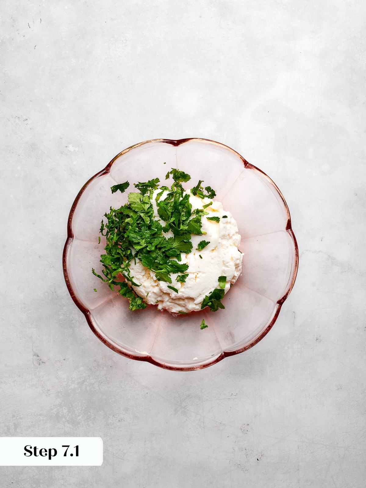 Preparing ricotta mixture with herbs for layering spaghetti squash lasagna filling.