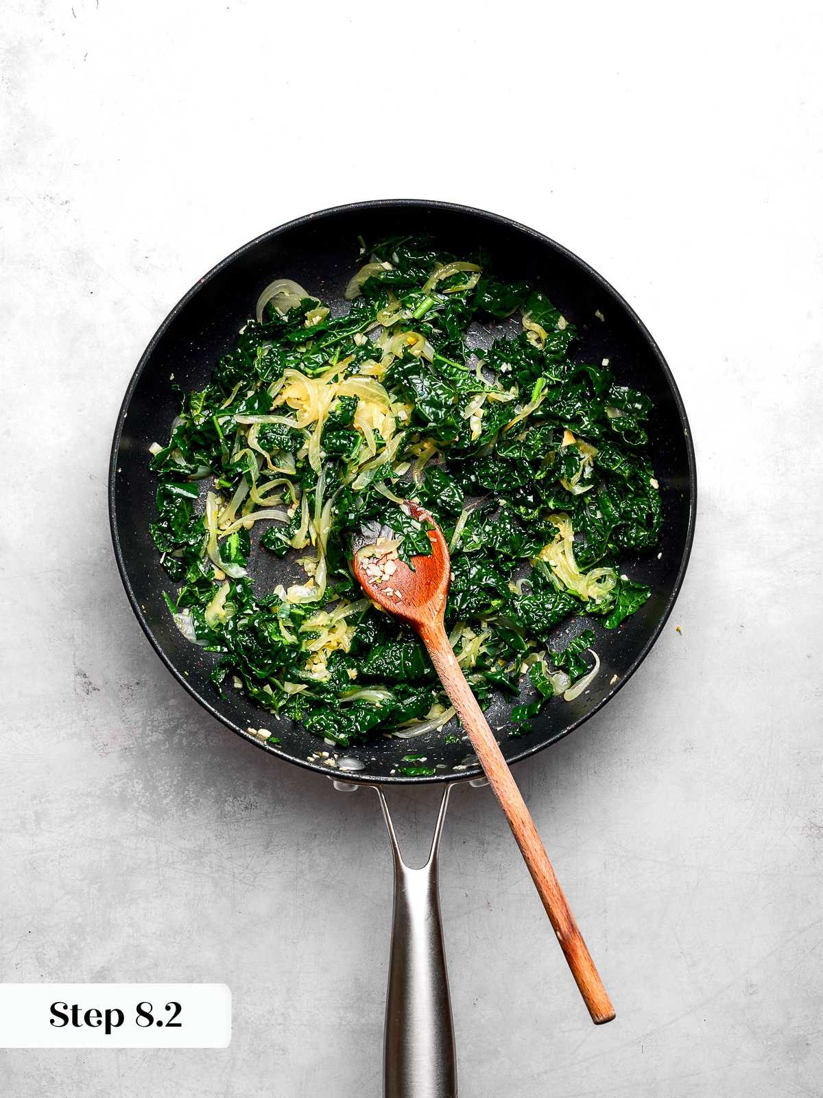 Sautéed kale and onions cooked until tender and combined for vegetable layer.