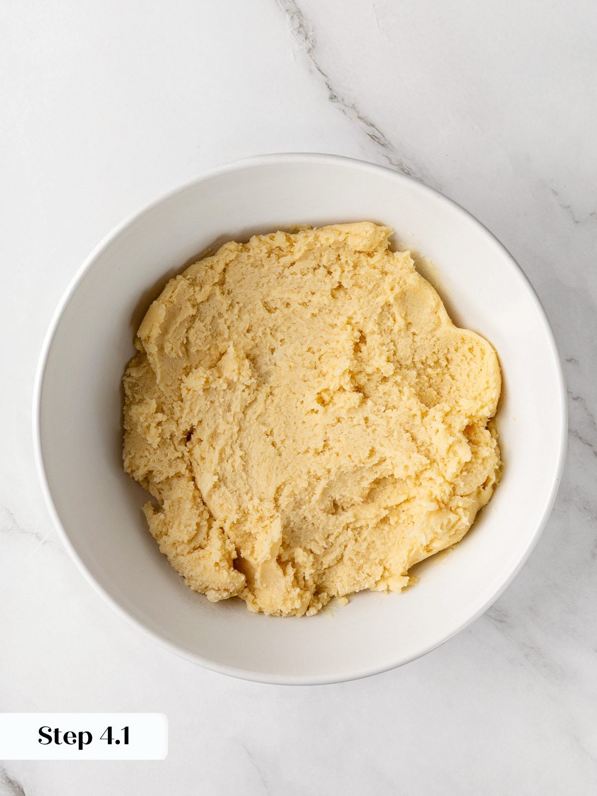 Flour mixture fully incorporated into dough creating thick, cohesive cookie batter.