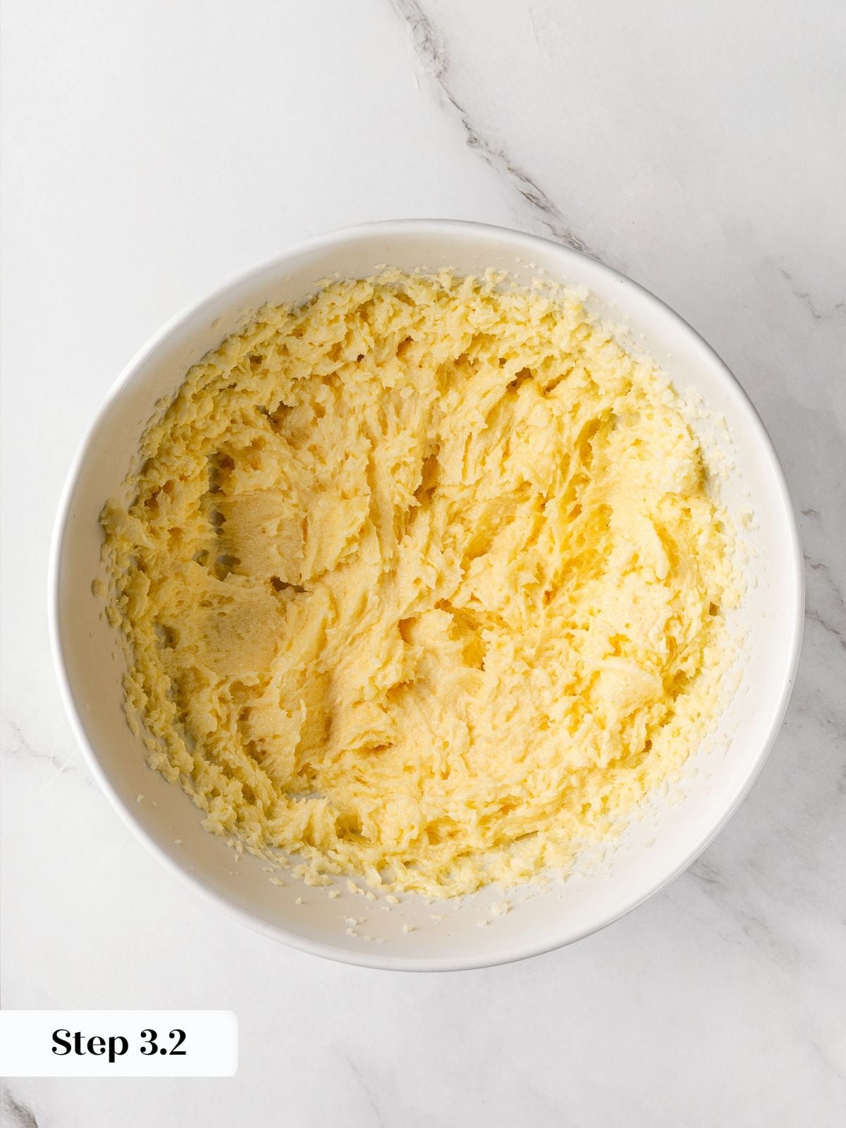 Cookie dough base after egg addition beginning to emulsify into cohesive batter.