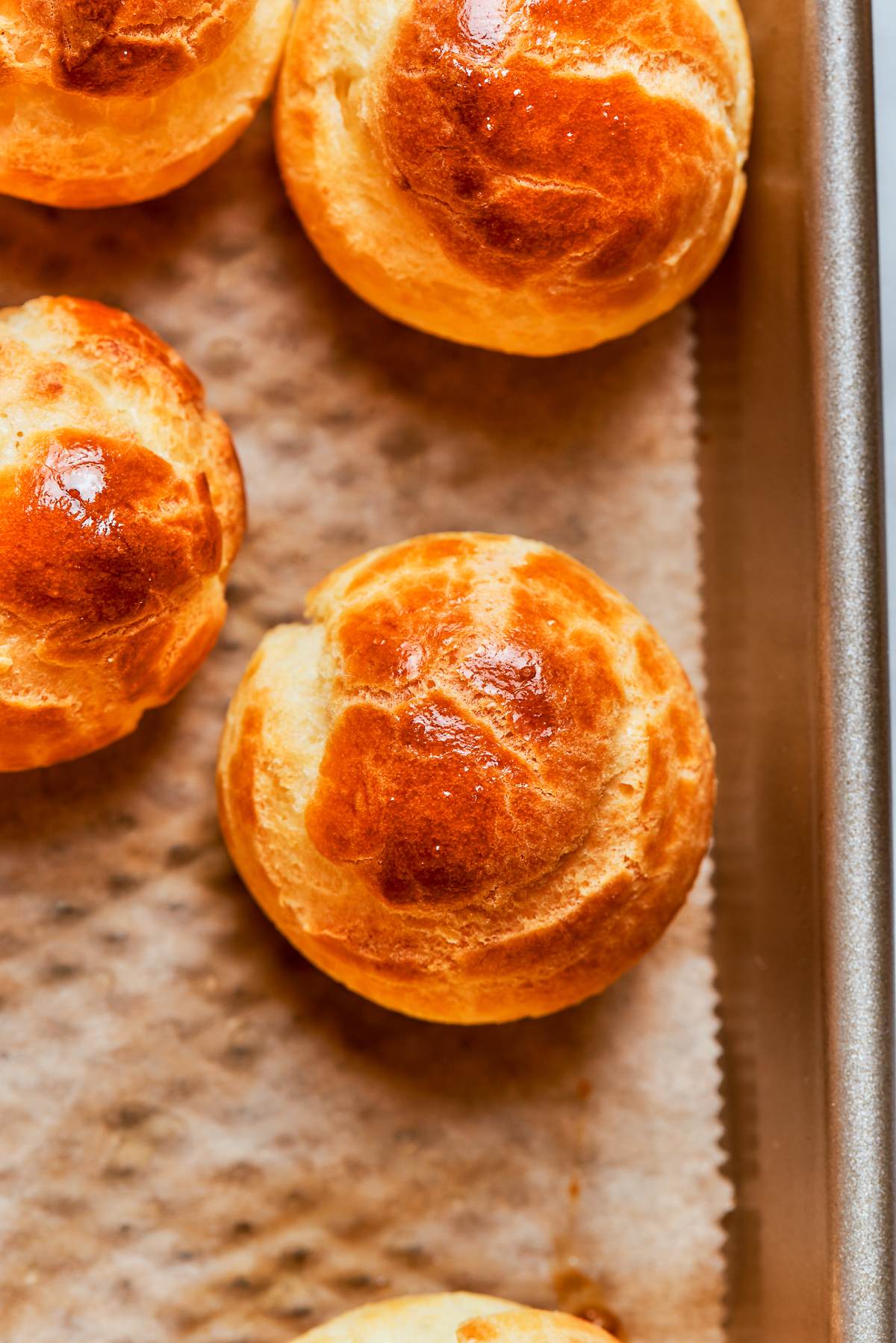 Golden choux pastry puff showing even browning and well developed crisp shell.