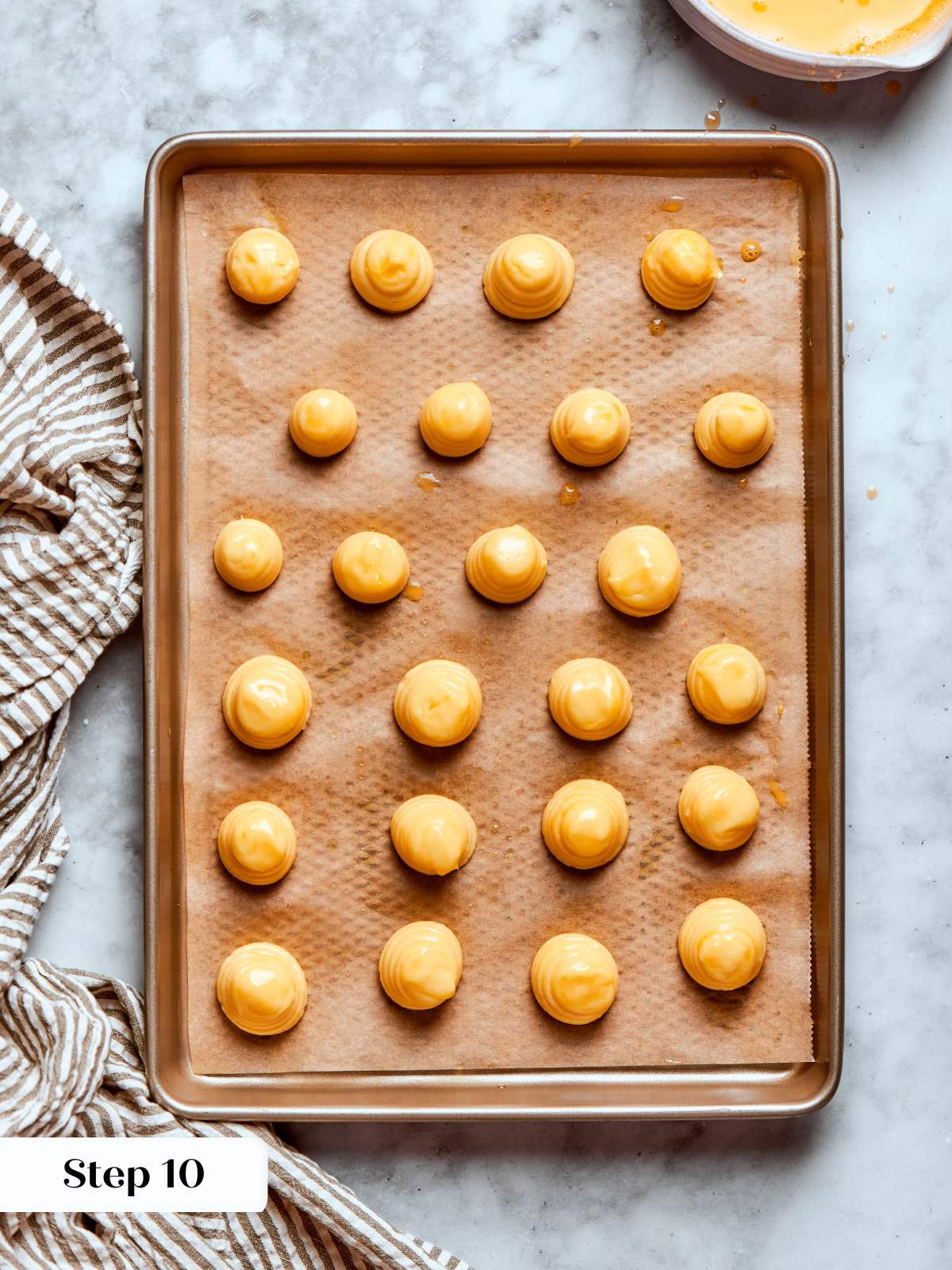 piped choux pastry rounds egg washed.