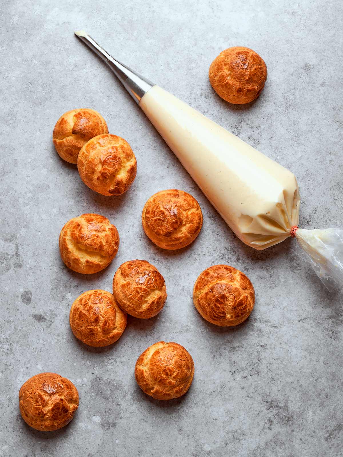 Piping bag filled with smooth crème légère ready for filling pastries or desserts.
