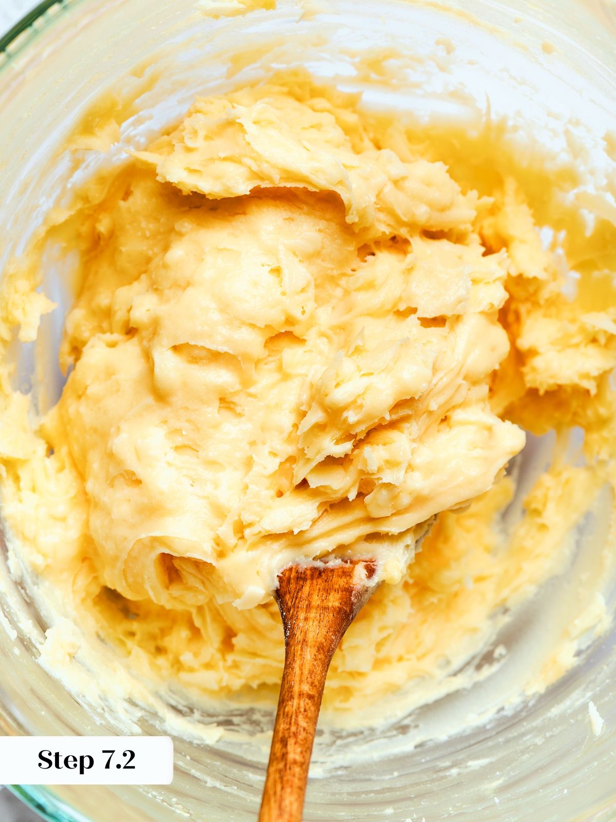 Choux dough mixed with shredded cheese evenly distributed throughout thick batter.