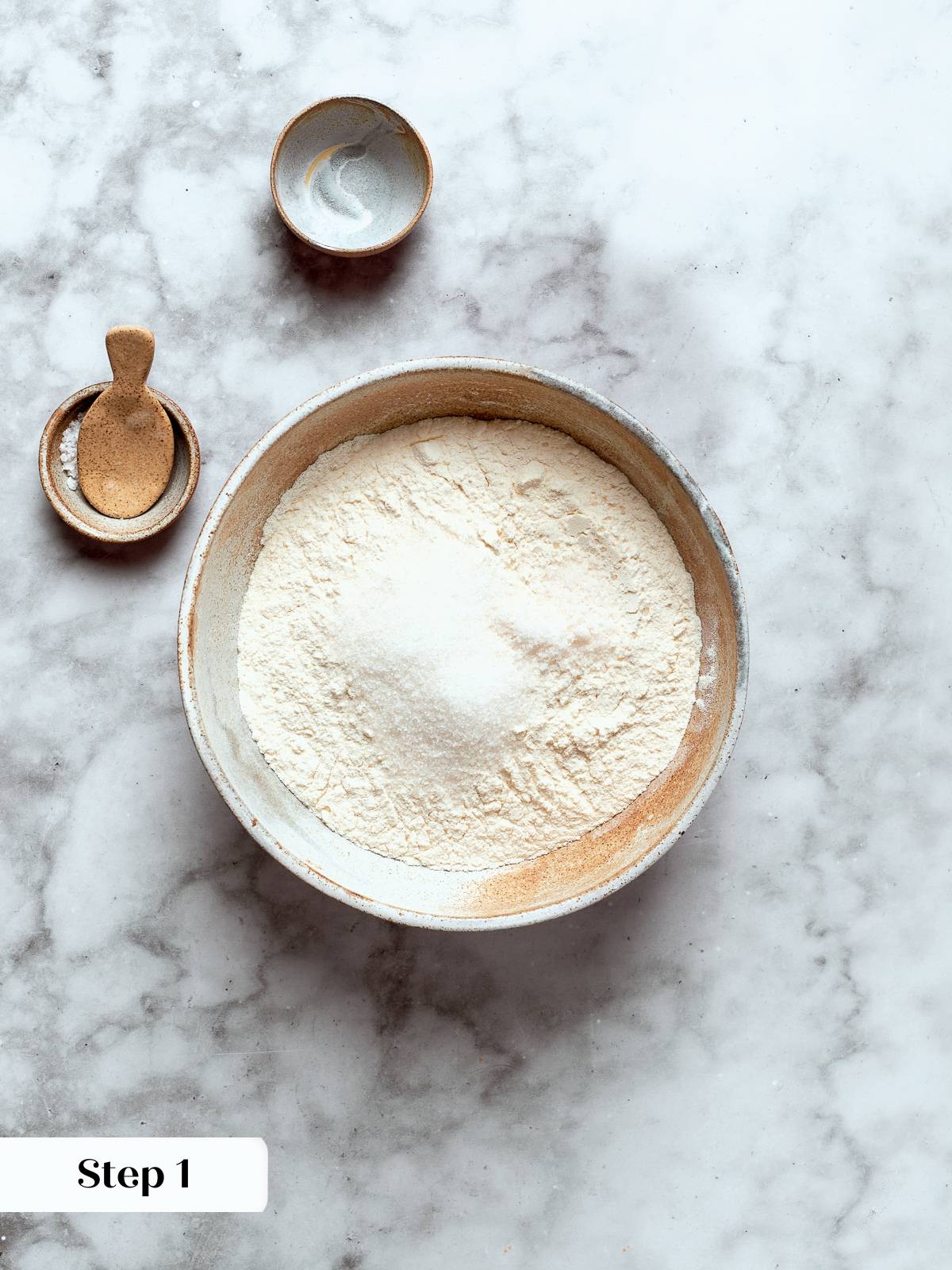 Flour, salt, and sugar combined in bowl ready for choux dough preparation.