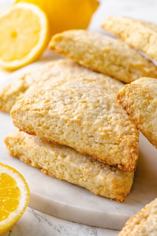 Several lemon scones arranged together showing uniform shape and lightly golden baked surfaces.