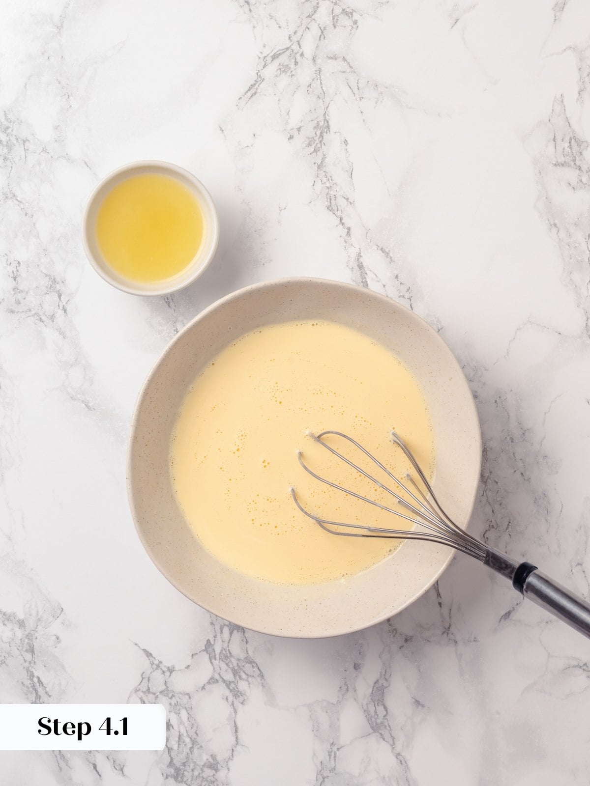 Eggs and cream whisked together until smooth forming liquid mixture for scone dough.