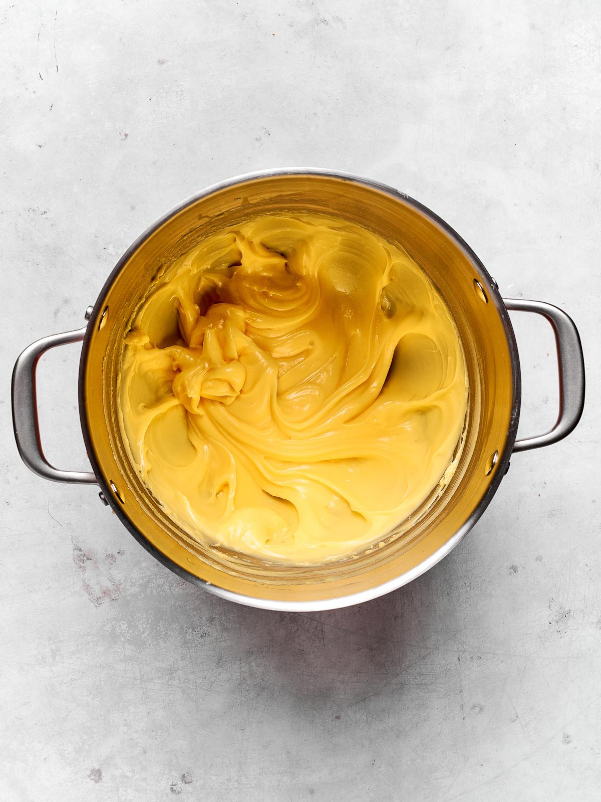 Pastry cream being mixed in a bowl until smooth and ready for use.