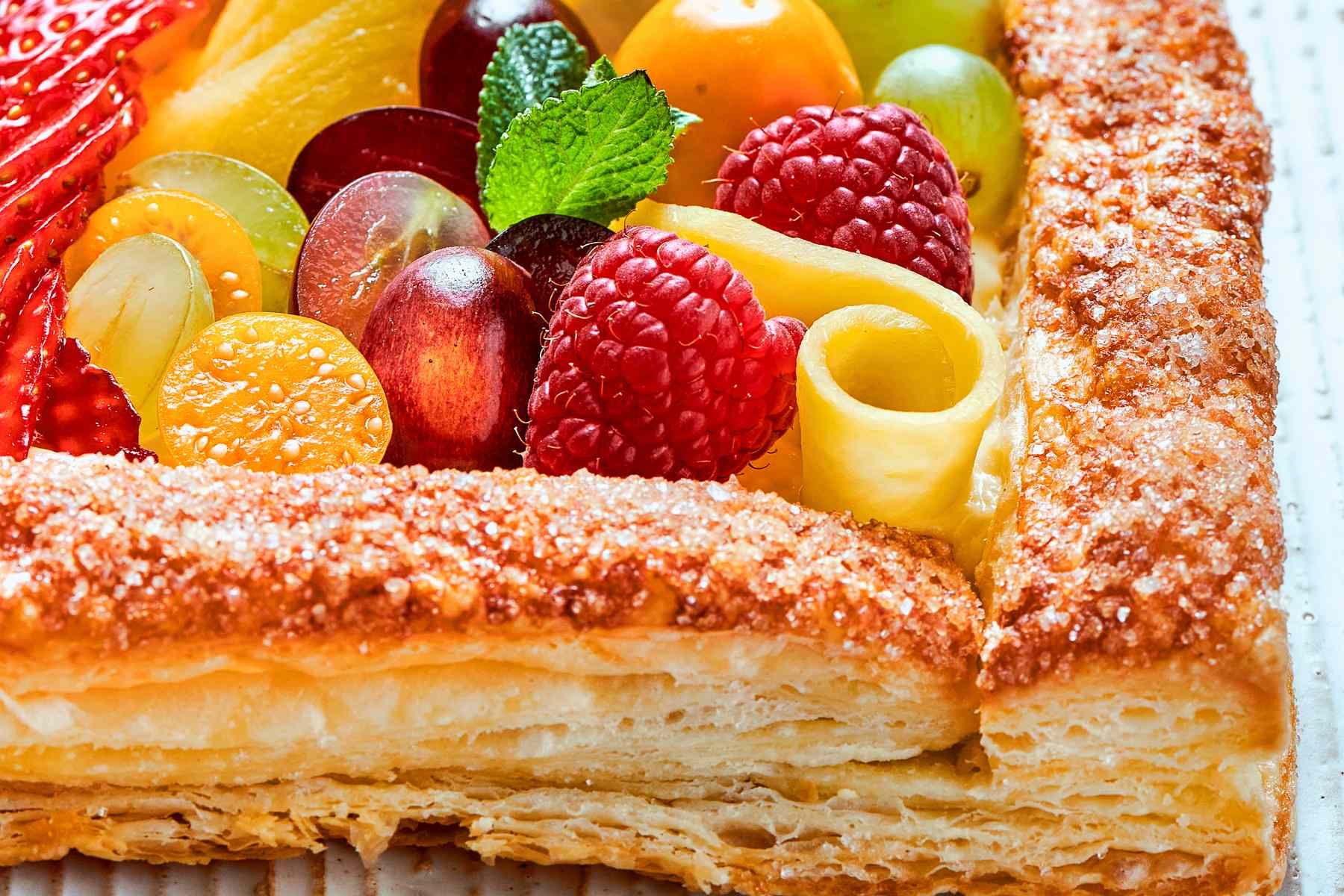 Puff pastry edges coated with sugar, baked until golden and crisp.