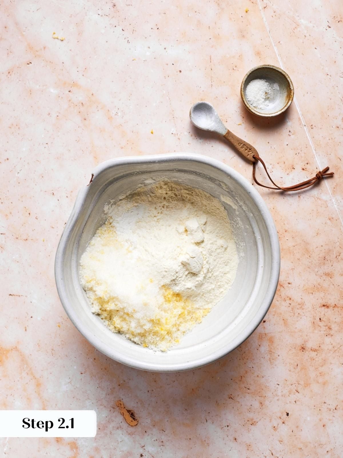 Dry ingredients staged in a ceramic bowl, ready for cold butter and the blueberry scones dough.