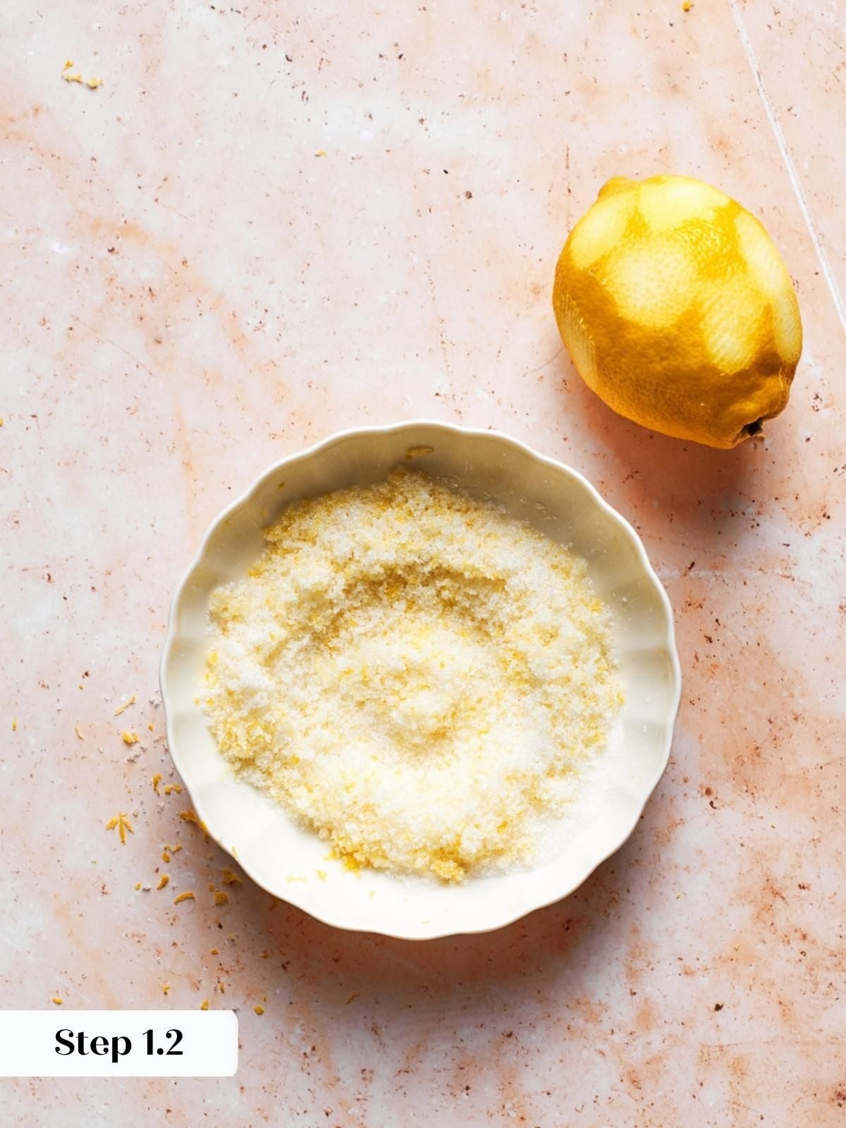 Lemon sugar rubbed together in a fluted dish, ready to flavor the blueberry scones recipe dough.