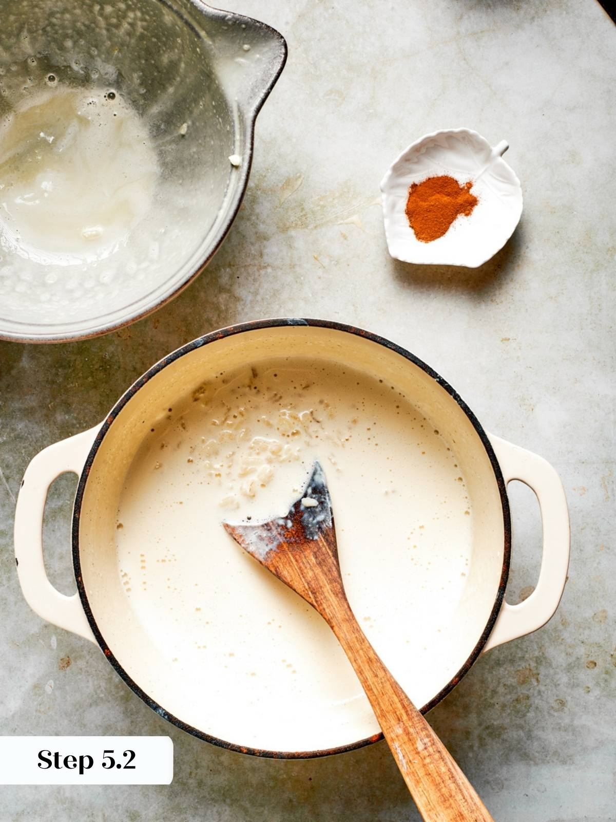 Tempered egg and rice mixture returned to the pot to finish cooking for rice pudding recipe.