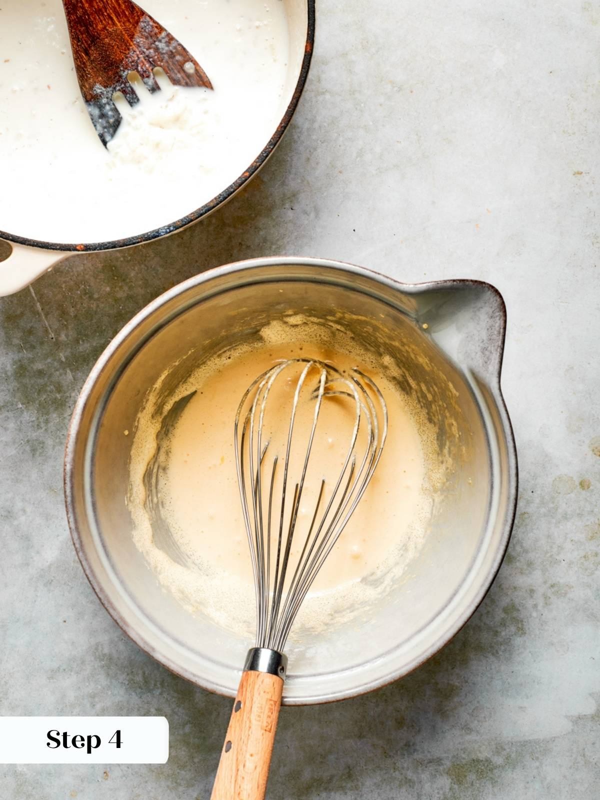 Cooked arborio rice in a saucepan beside a bowl of whisked yolks for rice pudding recipe.