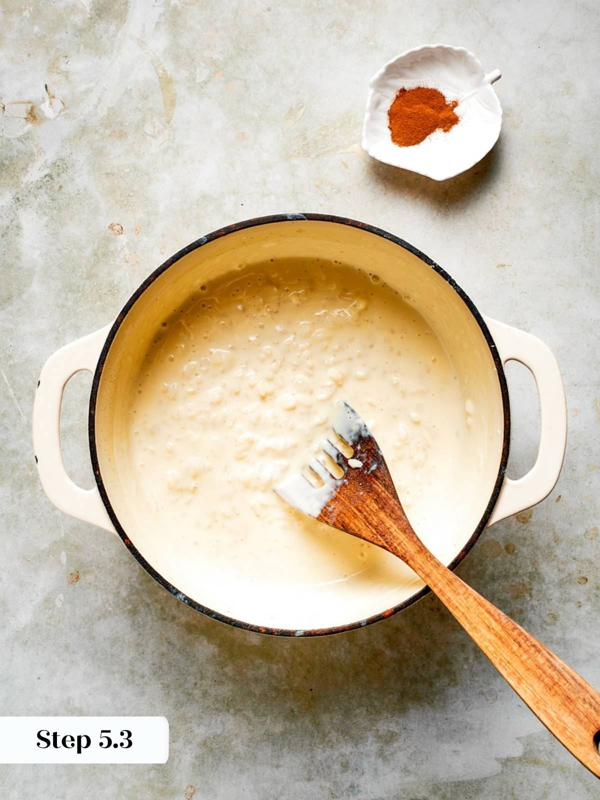 Thickened rice pudding gently simmering in the saucepan, ready to chill for the rice pudding recipe.
