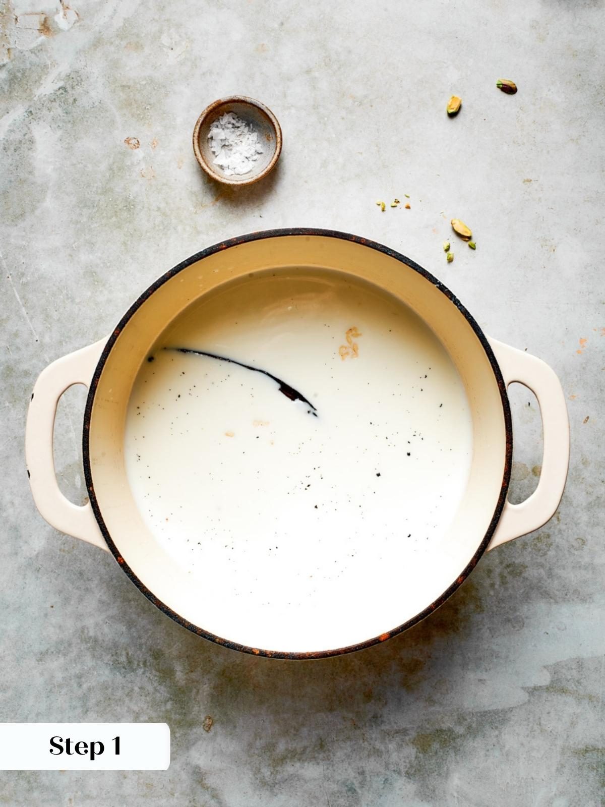 Whole milk and a split vanilla bean steeping in a pot to begin the rice pudding recipe.