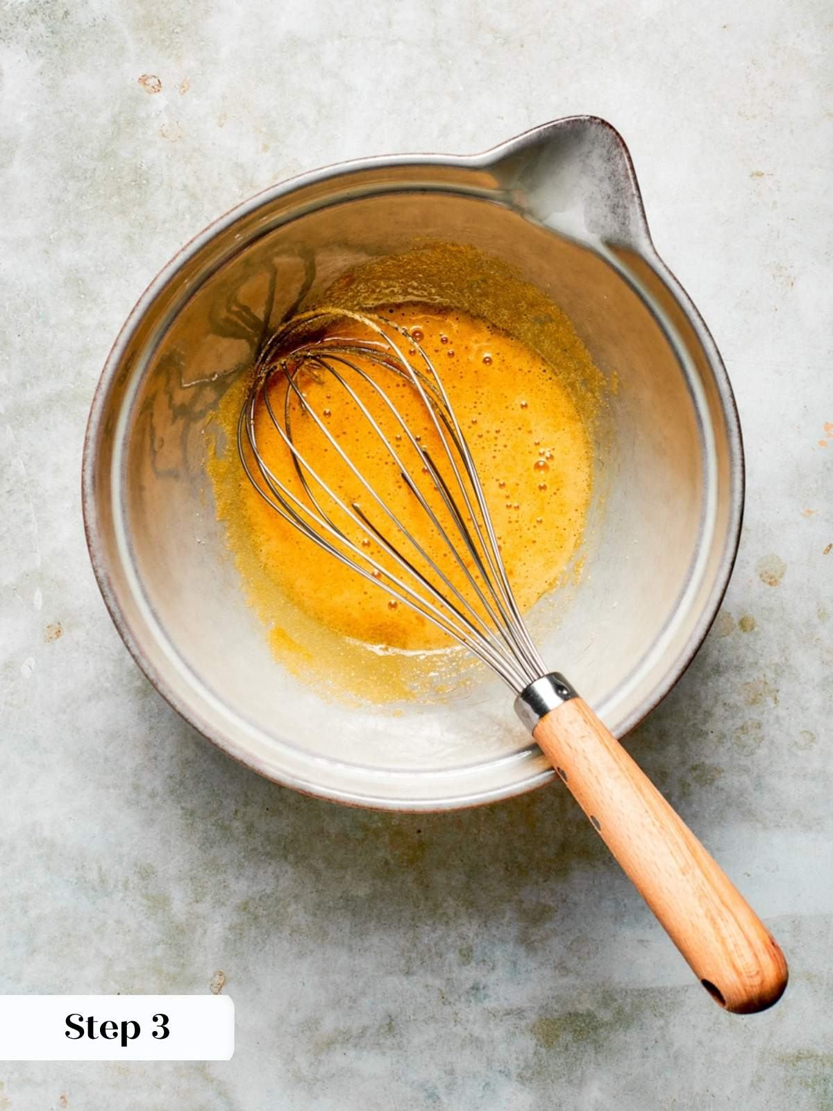 Whisked yolks ready to be tempered into the hot milk for this creamy rice pudding recipe.