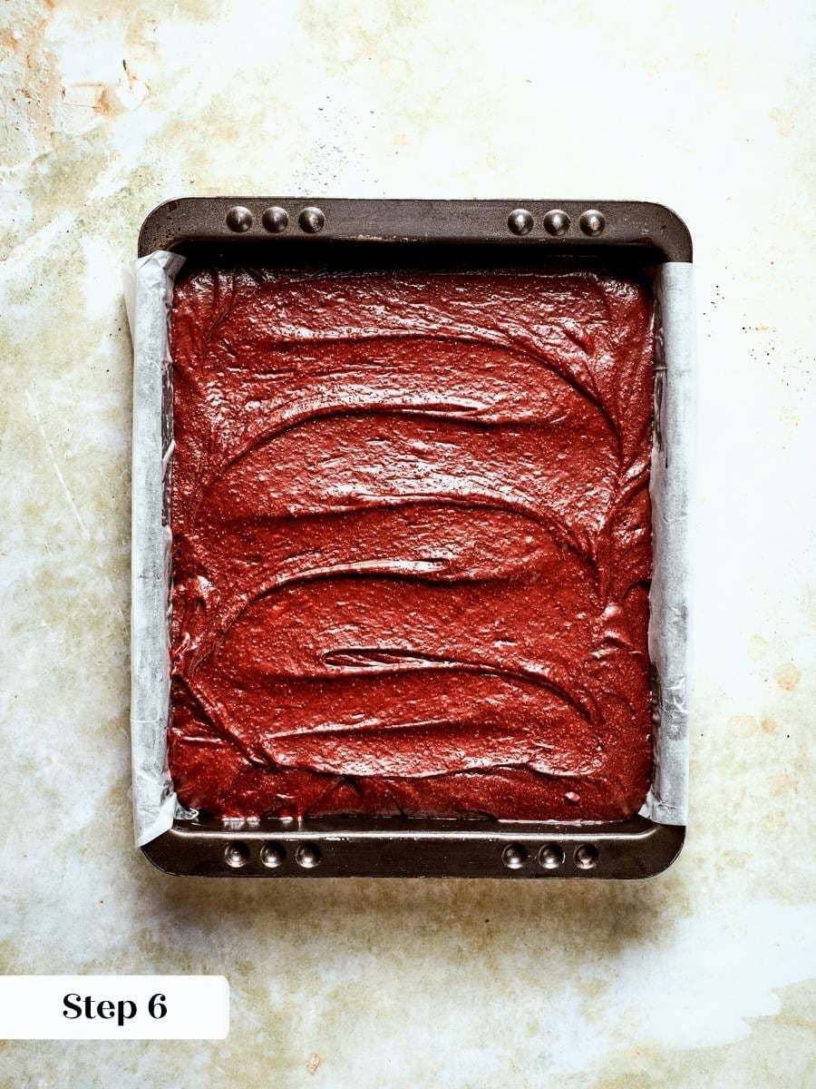 Parchment overhang acts as handles for lifting the whole slab of one bowl brownies out cleanly.