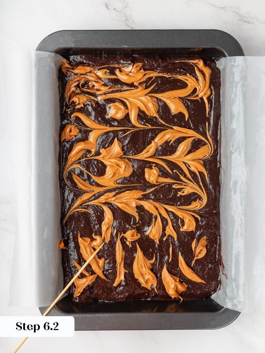Natural peanut butter ribbons through the batter, the signature swirl that defines these peanut butter brownies.