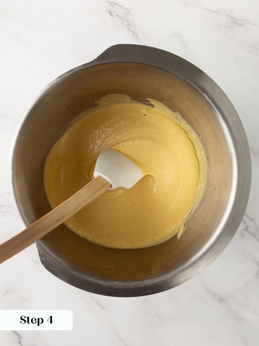 That extra yolk, whipped in here, gives brownie cookies their dense, fudgy center after baking.