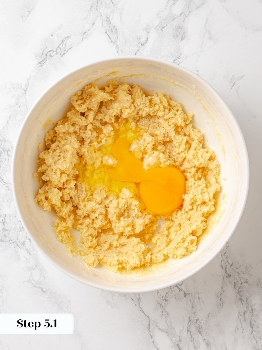 Beating the eggs in one at a time keeps the crumb cake batter smooth and emulsified.