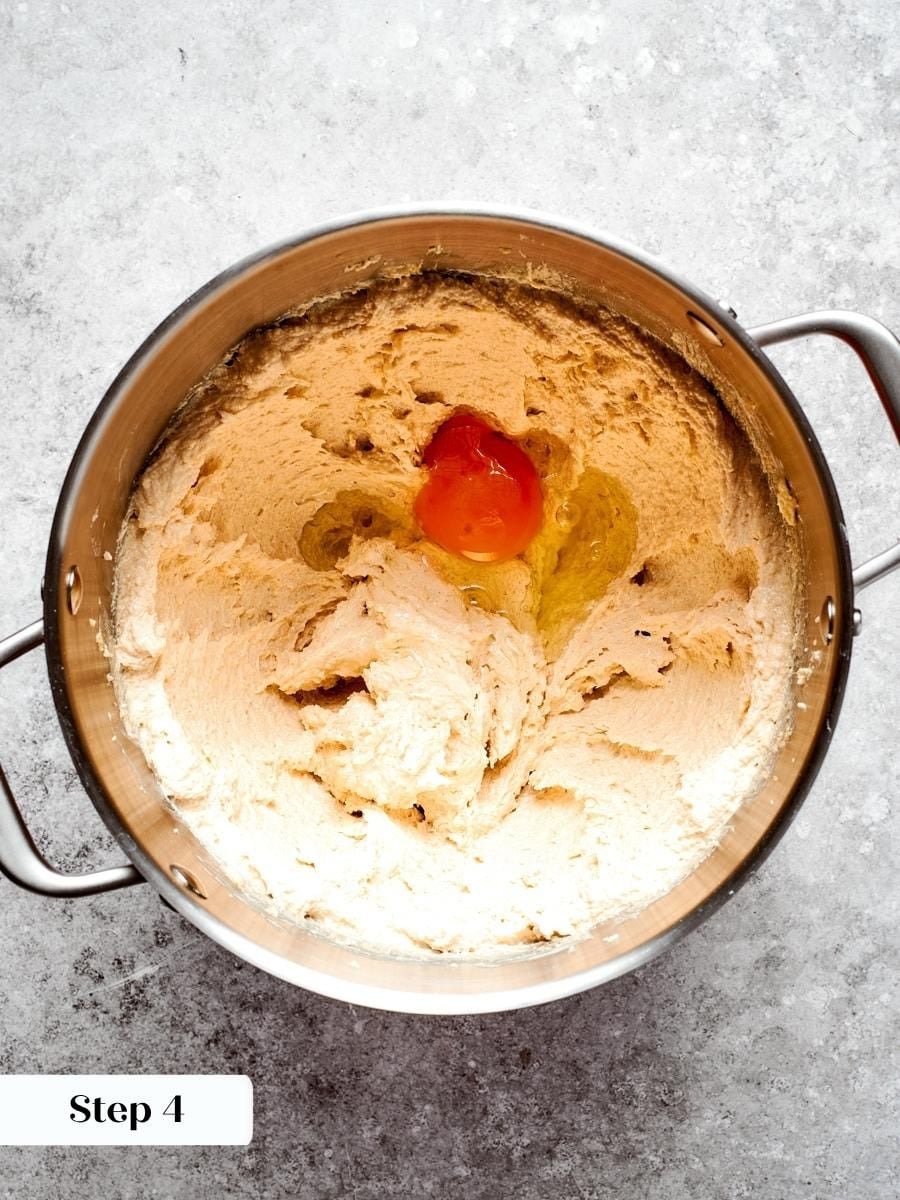 A room-temperature egg blends in smoothly, binding the oatmeal cream pie dough without breaking the emulsion.
