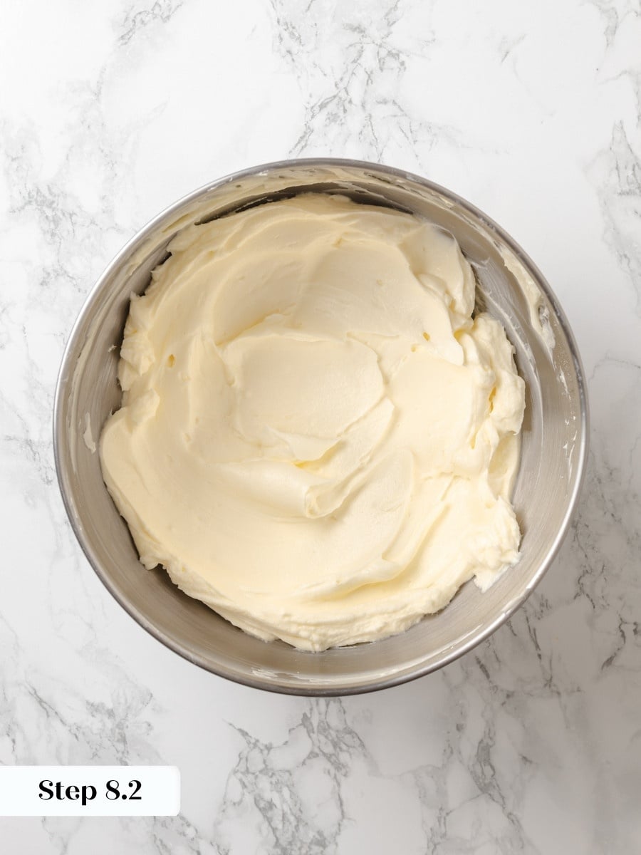Beating until silky gives the frosting enough body to hold clean layers on the pumpkin cake.