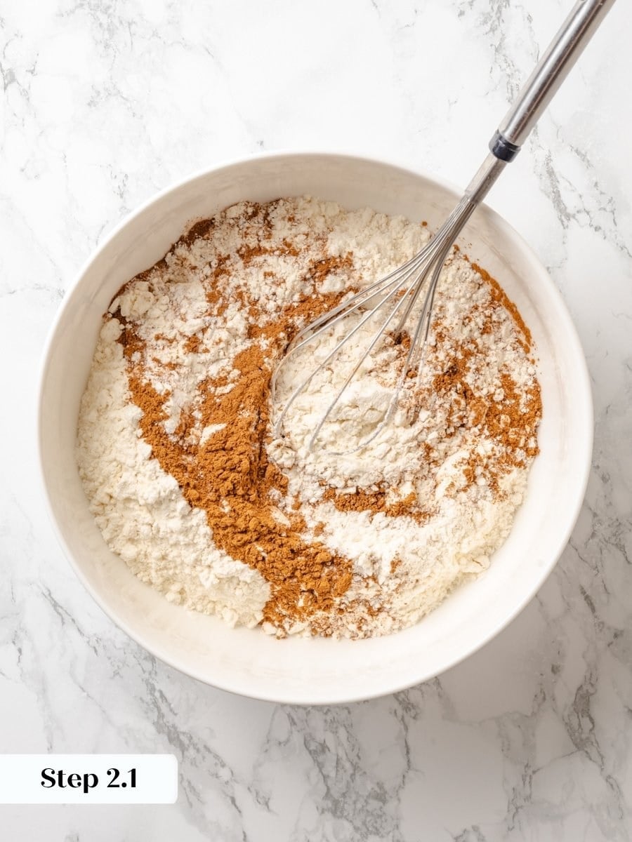 Whisking the dry spices evenly is the first step toward a warmly balanced pumpkin cake crumb.